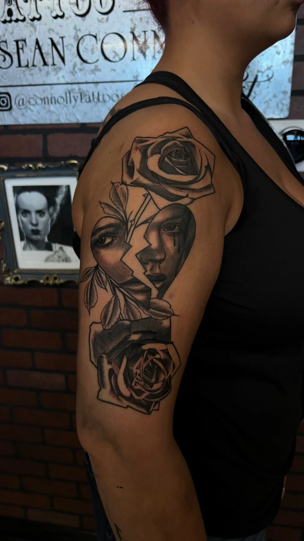Black and grey illustrative broken-face and rose tattoo