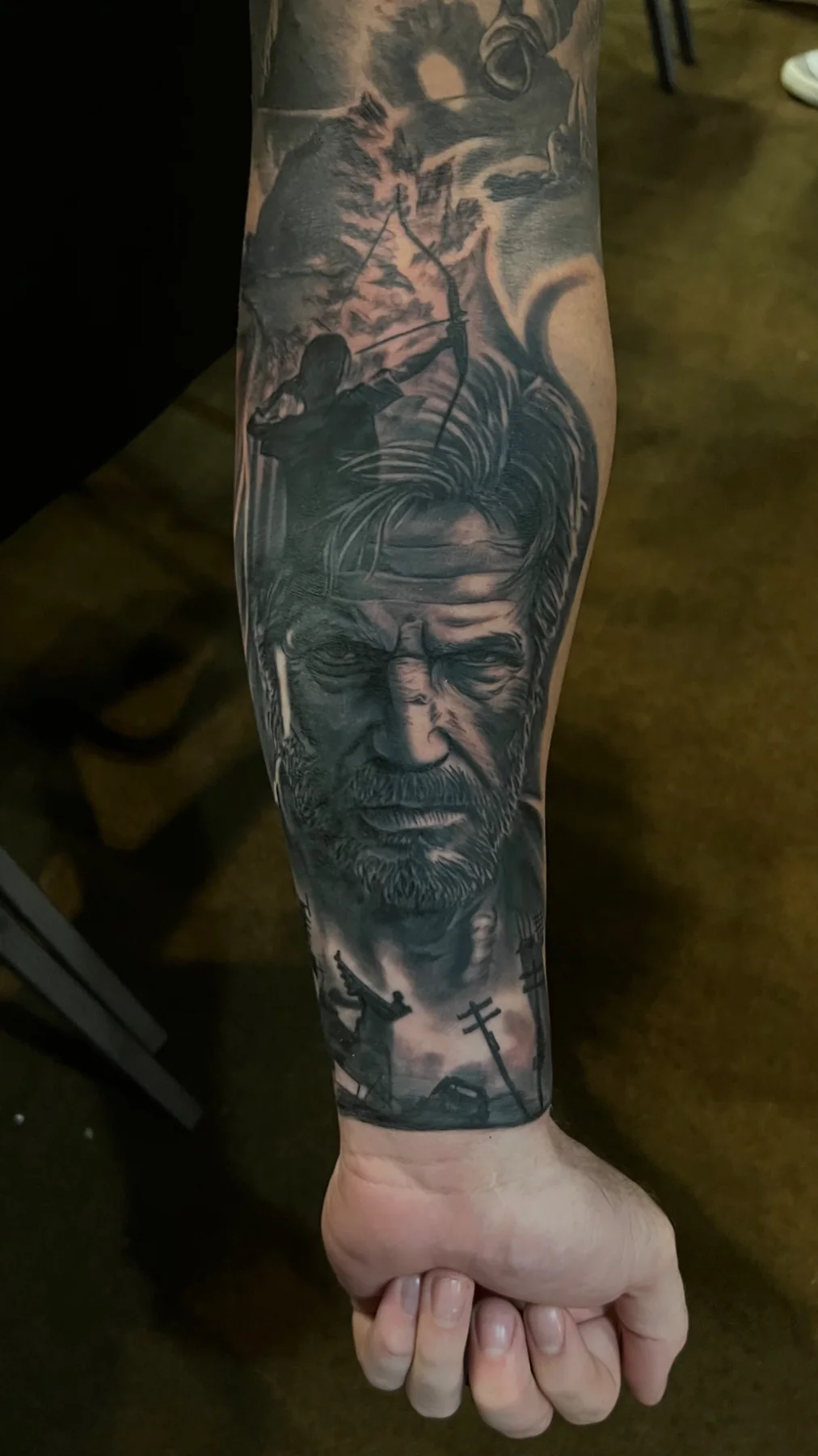 Black and grey cinematic realism forearm tattoo